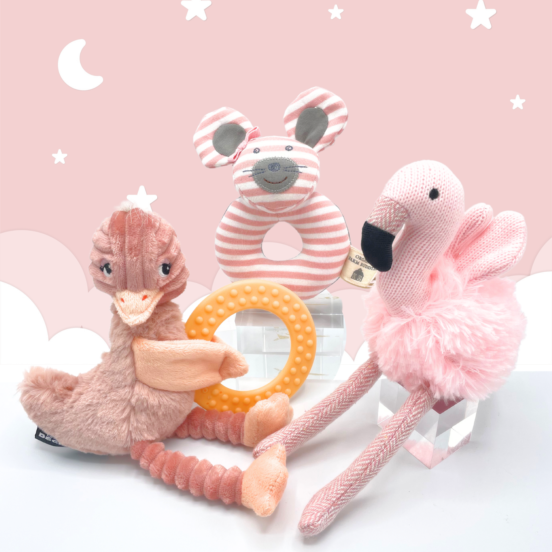 Joyful Jellybean Blush Pink themed toys including a baby toy flamingo rattle, baby toy mouse maraca and baby toy ostrich teether