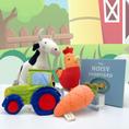 Load image into Gallery viewer, Joyful Jellybean Farmyard themed toys including a baby toy tractor, baby toy carrot, baby toy rooster, baby toy cow and baby toy farm activity book
